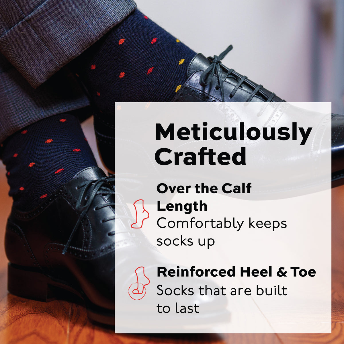 mans legs crossed at the ankle wearing black oxfords and over the calf merino wool navy socks with a tri-color dot pattern