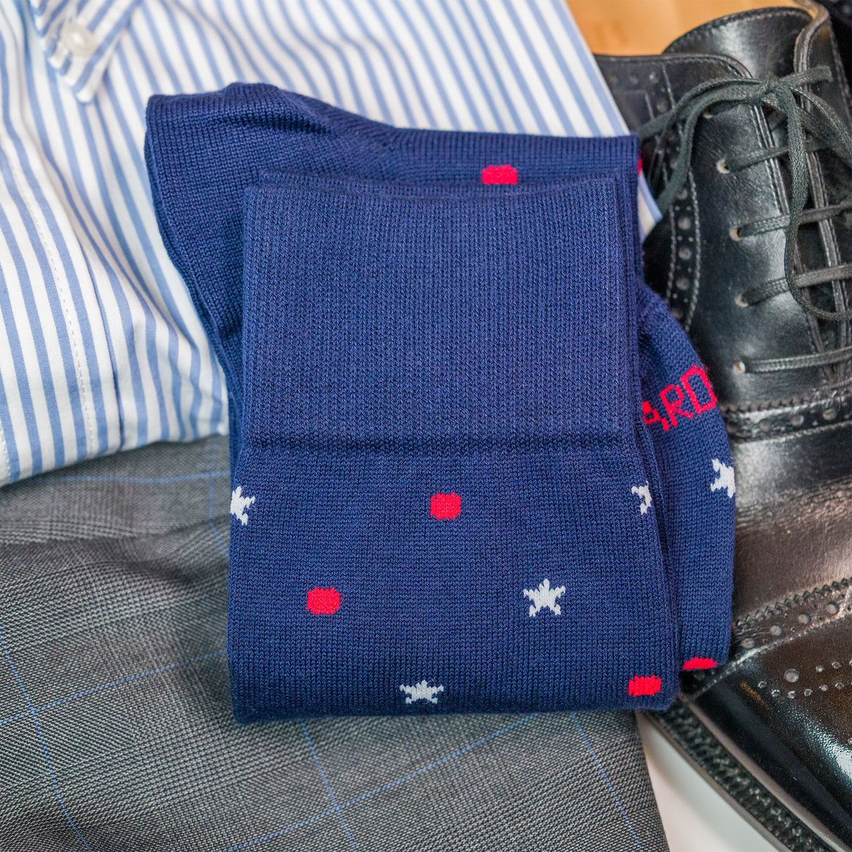 cotton star and dot patterned dress socks folded laying on top of clothing