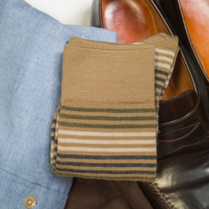 pair of khaki wool striped dress socks atop business casual attire
