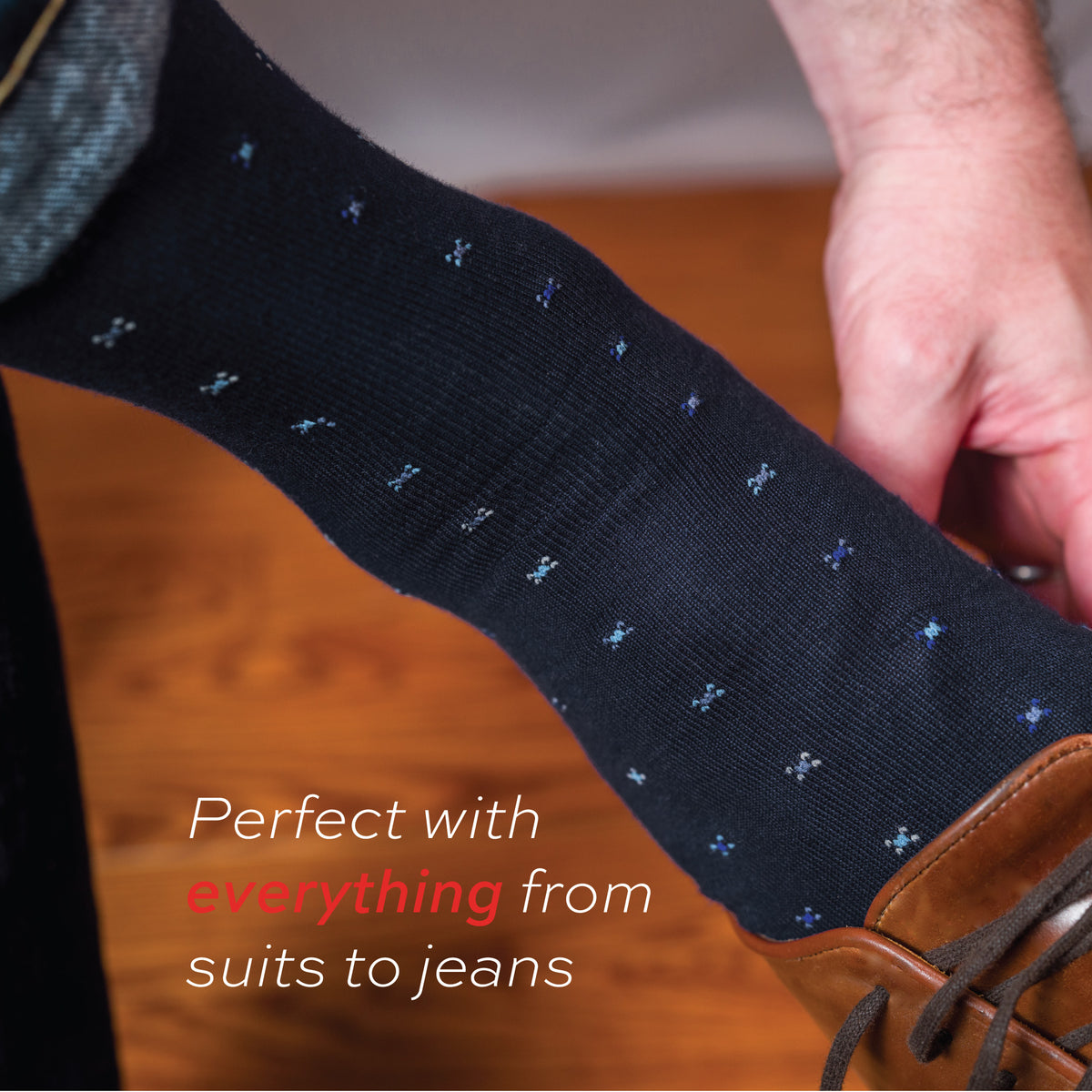 man putting on shoes wearing Navy Geometric Merino Wool Over the Calf Dress Socks