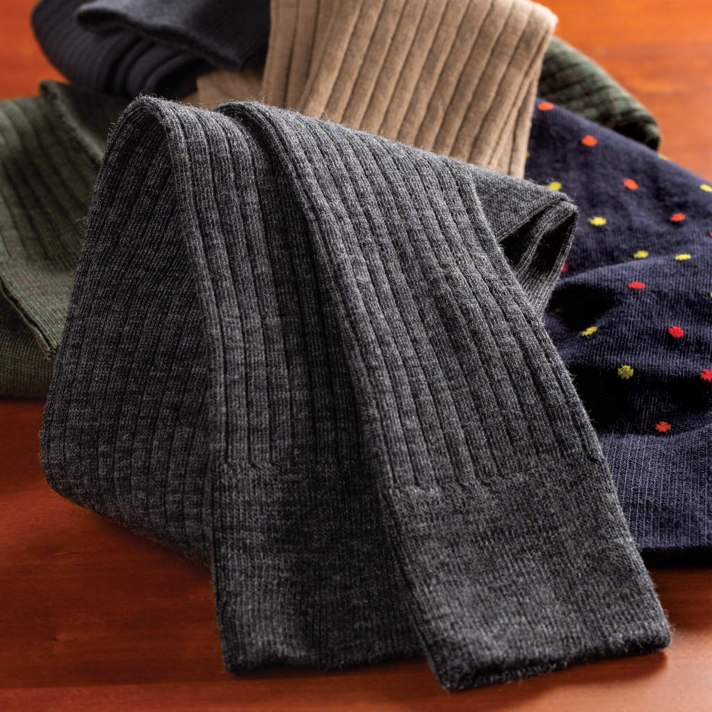 pile of Boardroom Socks men's dress socks on wooden table