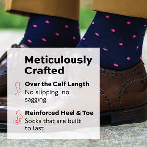 pink dots on navy cotton over the calf dress socks worn by a man standing