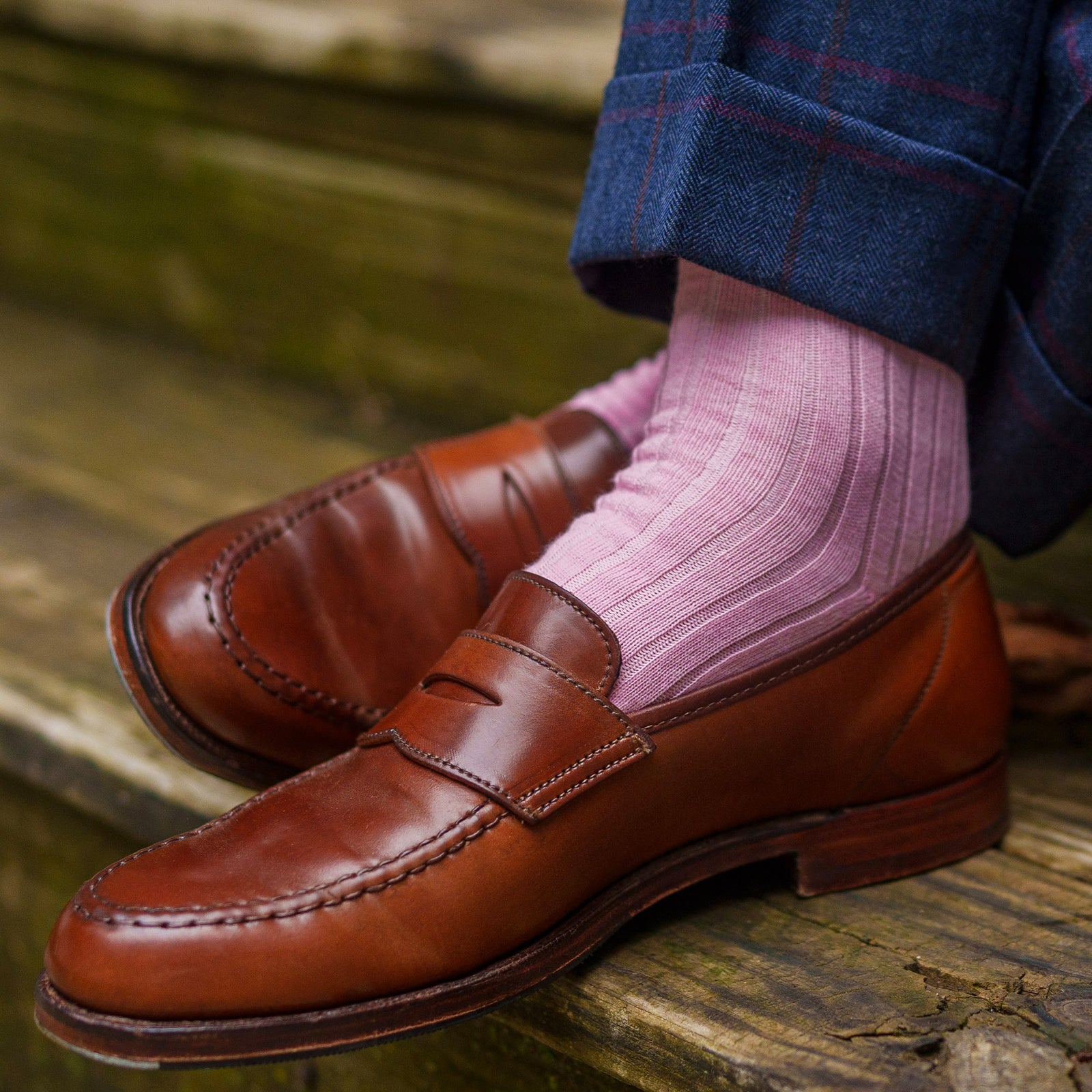 close up of pink merino wool dress socks on man sitting on stairs