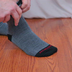 video of man putting on herringbone dress socks and wearing them with a stylish outfit