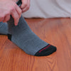 video of man putting on herringbone dress socks and wearing them with a stylish outfit