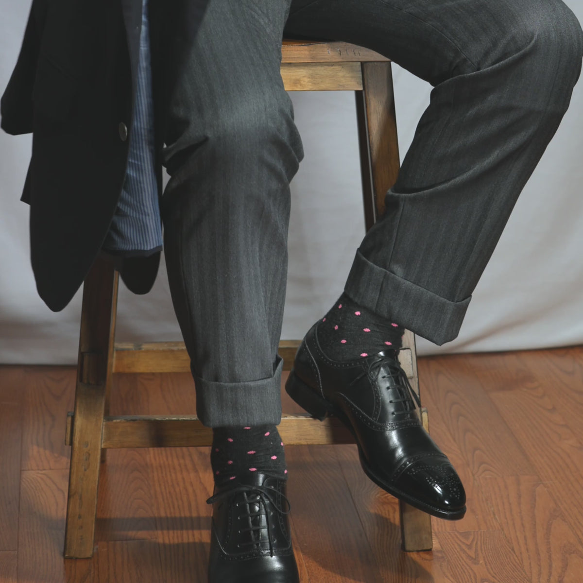 video highlighting stylish charcoal grey dress socks decorated with small pink polka dots