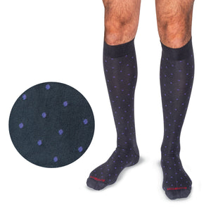 model wearing over the calf purple dots on grey cotton dress socks with a close up of the details to the side of the model's legs