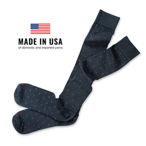 flat lay of purple dots on grey cotton socks with made in the usa of domestic and imported yarns text overlay