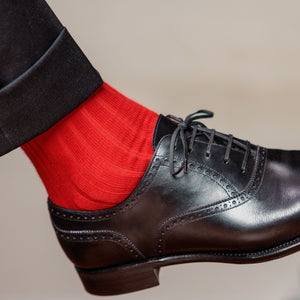 bright red men's dress socks with charcoal slacks and oxfords