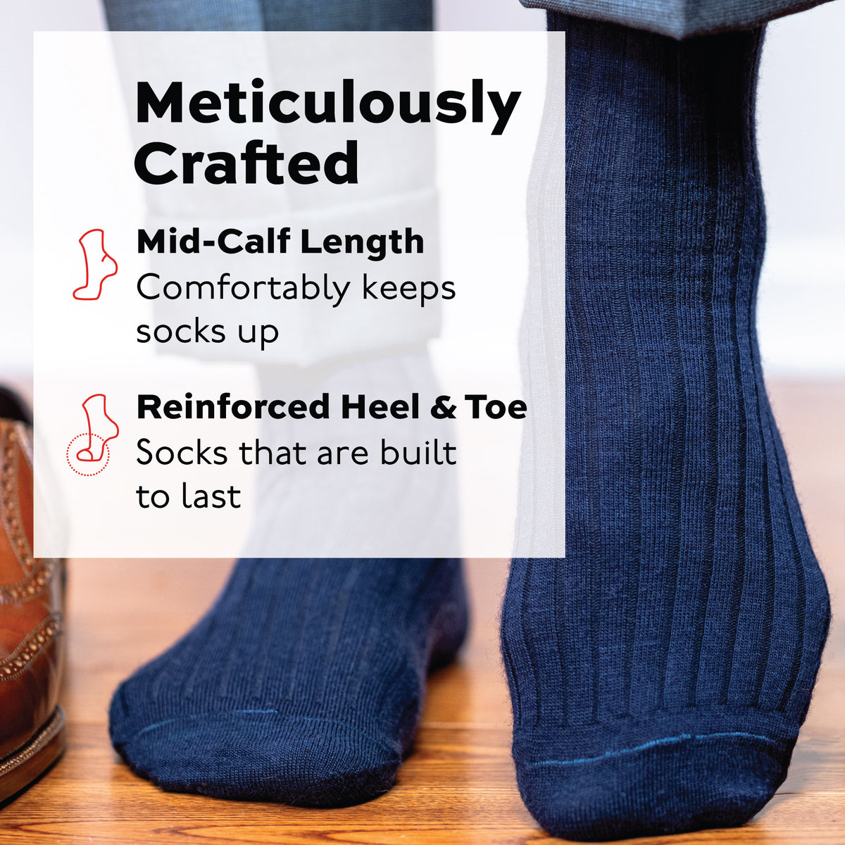 person standing wearing navy ribbed merino wool dress socks mid-calf length