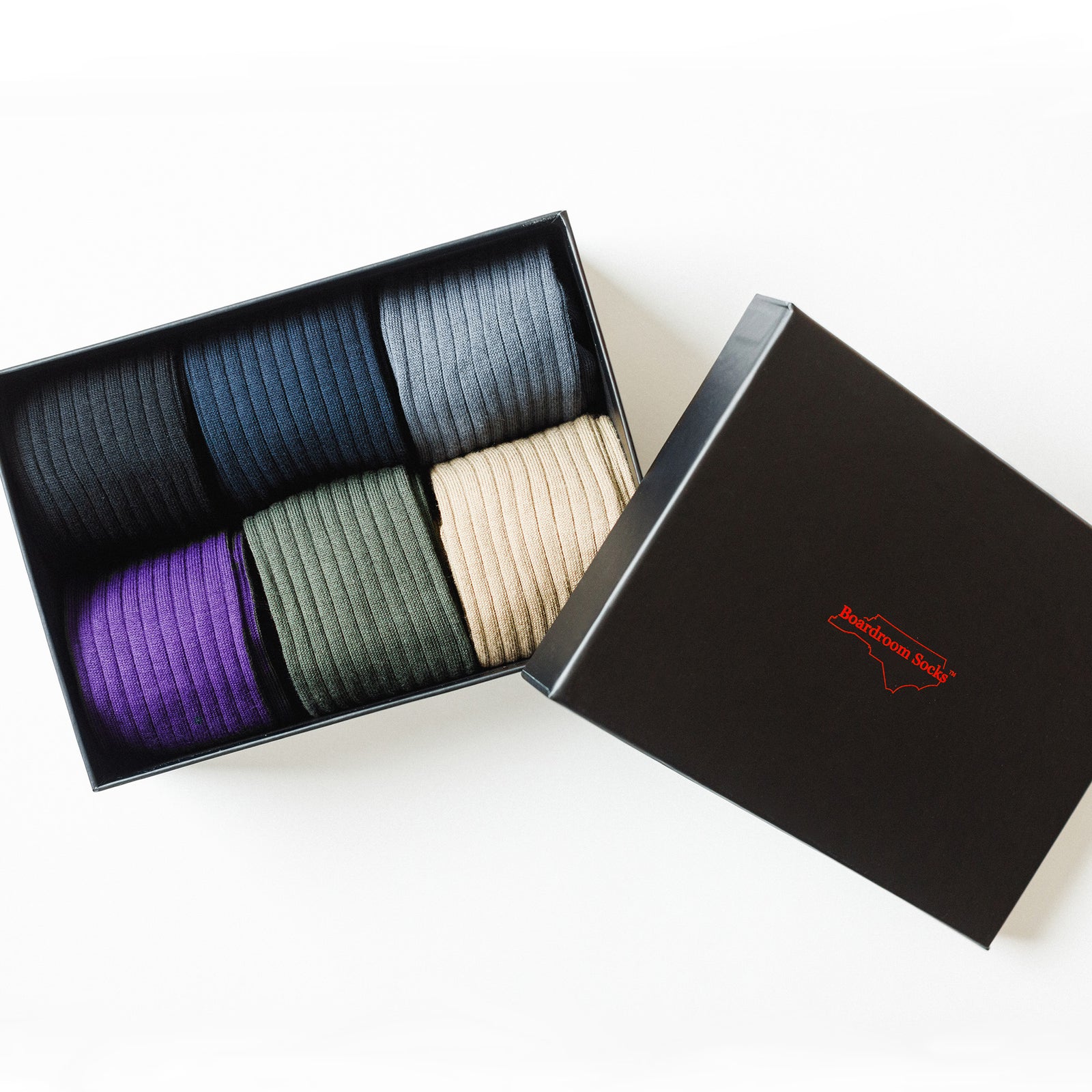 six pairs of multi-colored ribbed cotton dress socks in opened Boardroom Socks gift box