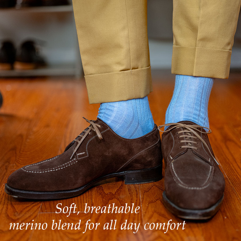man wearing sky blue dress socks with yellow slacks and dark brown suede derbies