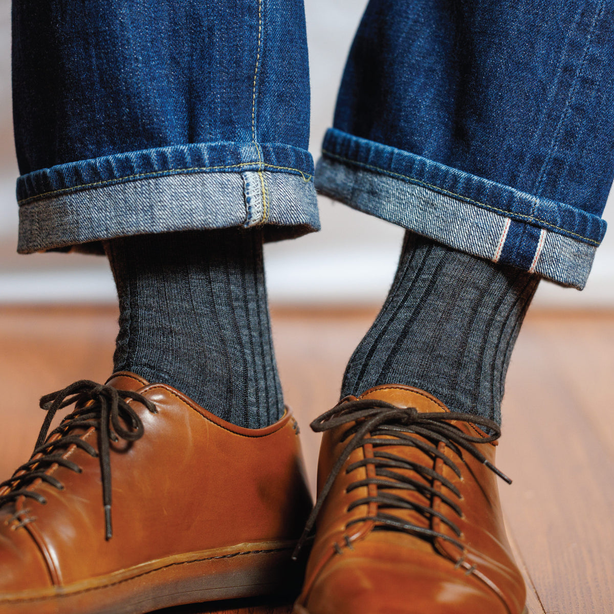 man wearing jeans, casual shoes and solid grey ribbed wool mid-calf length mean's dress socks