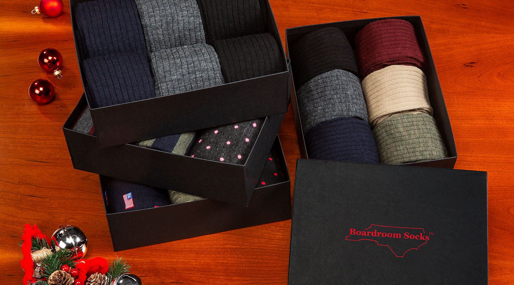 several Boardroom Socks gift boxes filled with a wide variety of colorful dress socks
