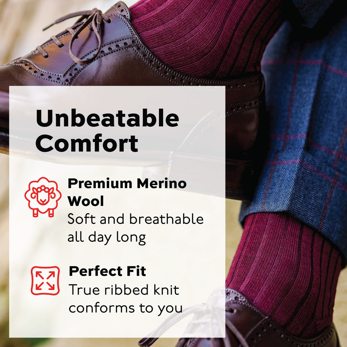 man crossing legs wearing burgundy merino wool mid-calf dress socks and brown shoes