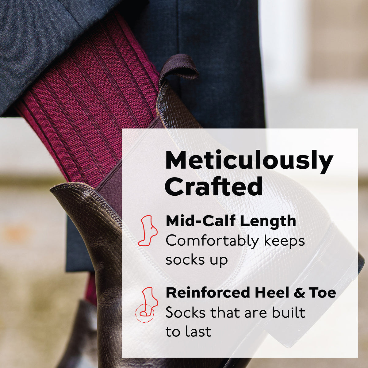 man standing wearing burgundy merino wool mid-calf dress socks and brown boots