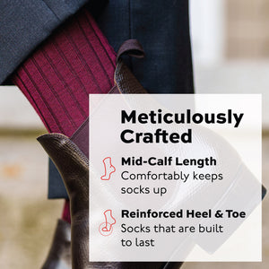 man standing wearing burgundy merino wool mid-calf dress socks and brown boots