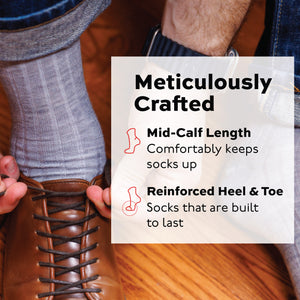 man putting on a shoe wearing light grey heather merino wool dress socks