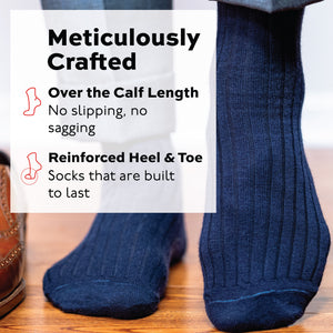 man standing on wood floor wearing navy wool over the calf mens ribbed dress socks