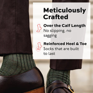 man standing wearing olive merino wool over the calf ribbed mens dress socks and brown pants