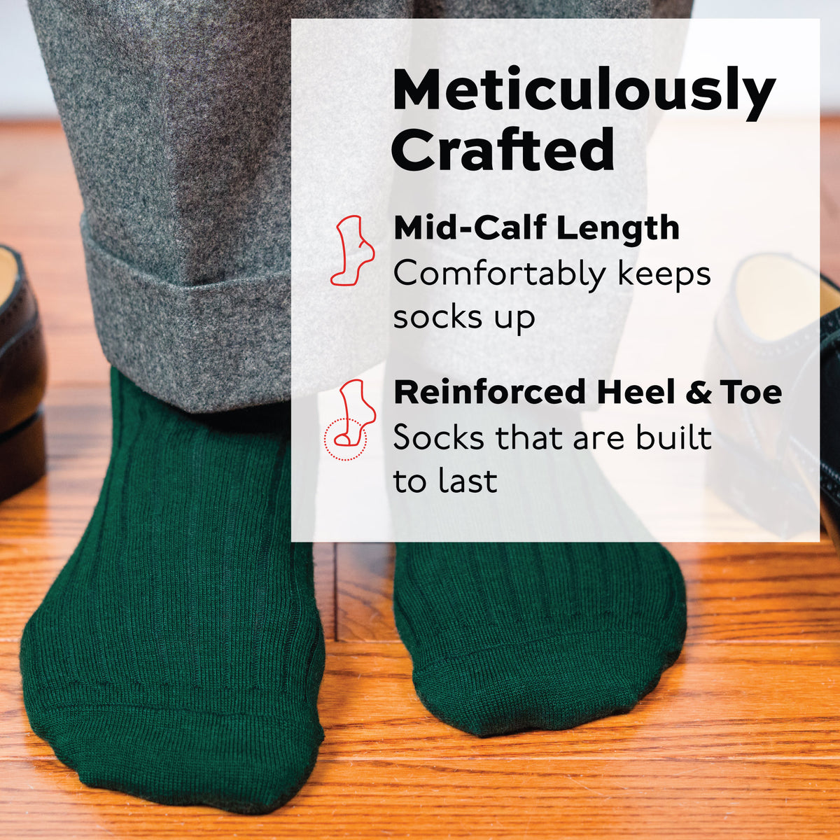 man standing on wood flooring wearing Forest Green Merino Wool mid-Calf Dress Socks and grey pants