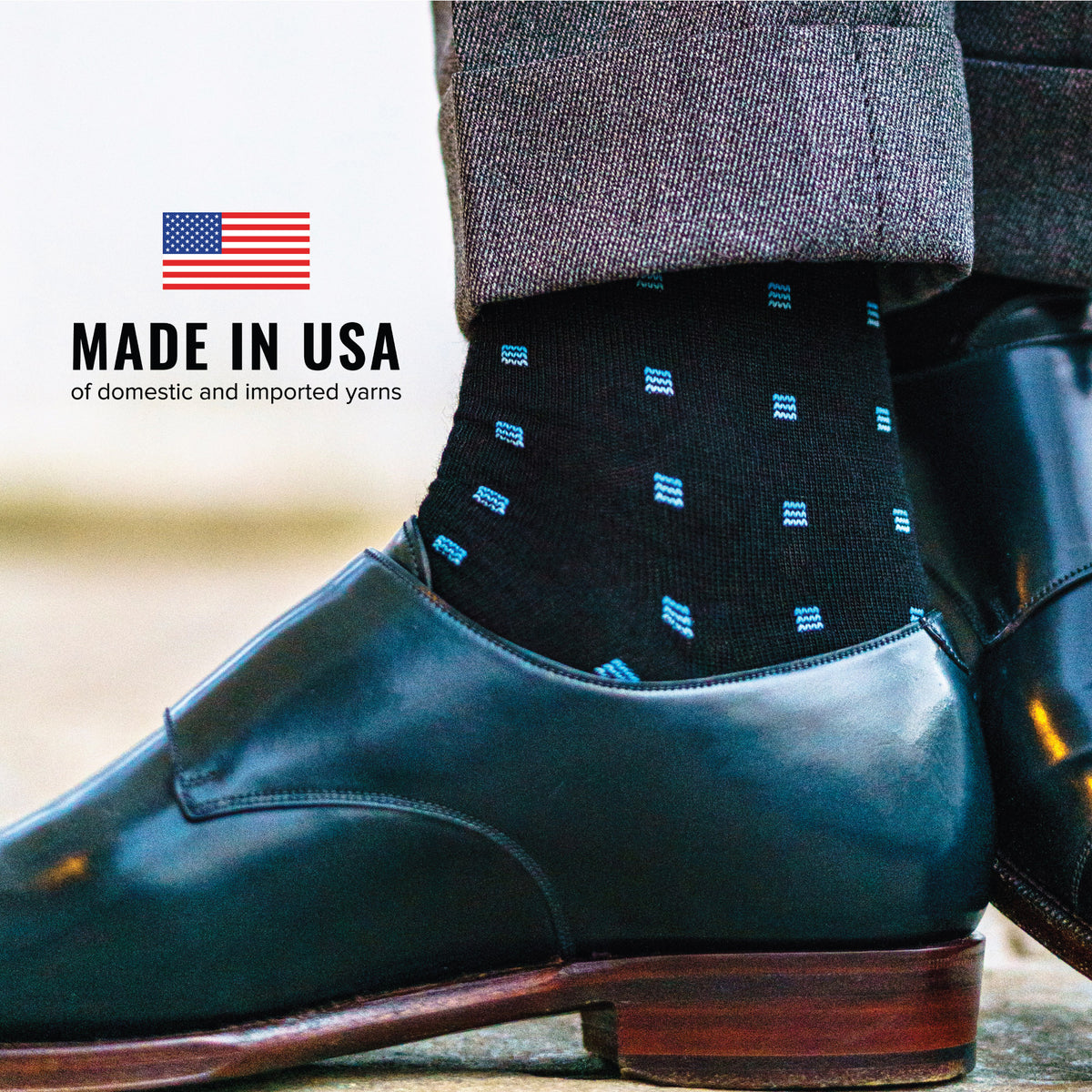 man wearing blue Square Knots on Black Merino Wool Over the Calf Dress Socks with an image of the american flag and made in USA text overlay