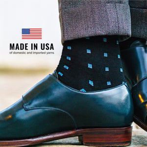 man wearing blue Square Knots on Black Merino Wool Over the Calf Dress Socks with an image of the american flag and made in USA text overlay