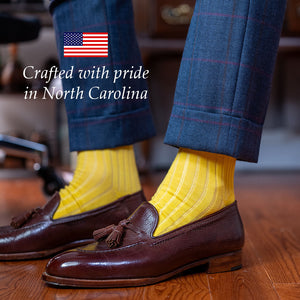 yellow cotton dress socks paired with a navy suit and dark brown tassel loafers