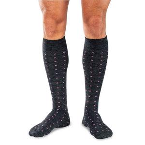 Man Wearing Charcoal Wool Over the Calf Dress Socks Decorated with Small Pink Squares