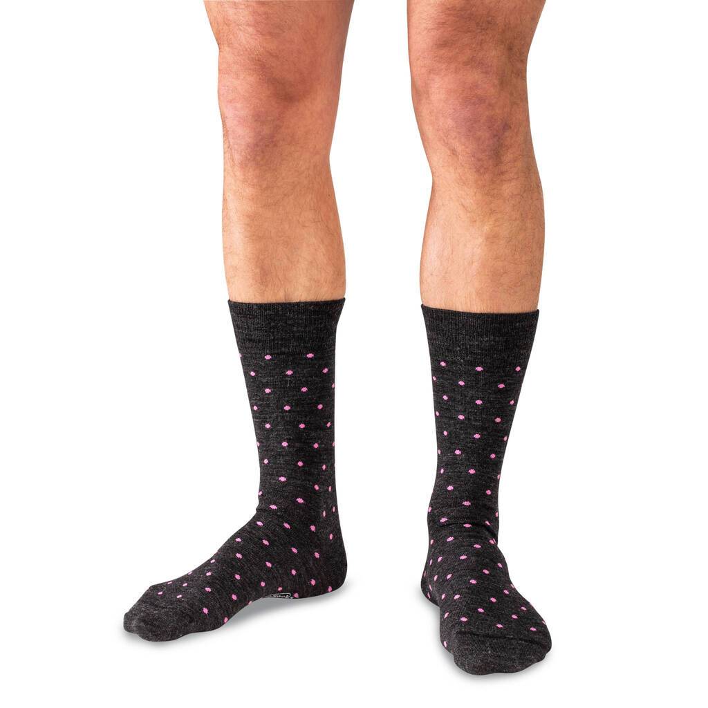 Man Wearing Mid-Calf Length Merino Wool Charcoal Dress Socks Decorated with Small Pink Polka Dots