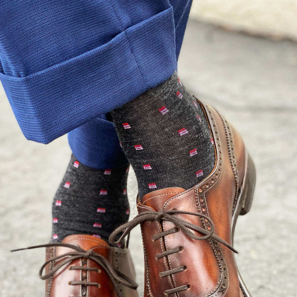 Man Wearing Charcoal Wool Patterned Dress Socks with Navy Blue Trousers and Brown Dress Shoes