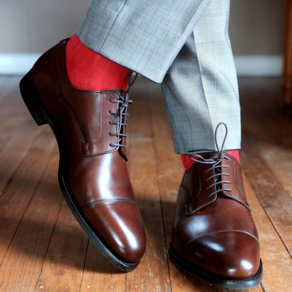 Man Wearing Grey Trousers with Red Dress Socks and Brown Captoe Dress Shoes