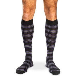 model wearing purple grey and black striped over the calf dress socks