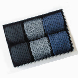 gift box filled with black grey and navy merino wool dress socks for men