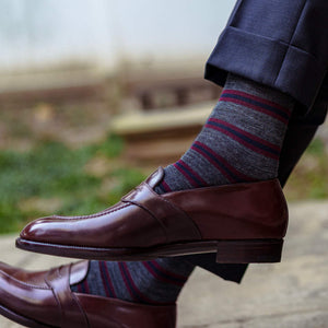 grey striped dress socks with navy trousers and dark brown penny loafers