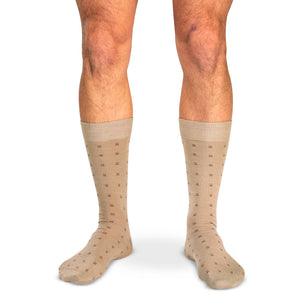 model wearing tan mid-calf dress socks with colorful square knots