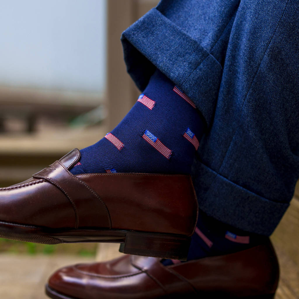 man crossing legs wearing American flag dress socks