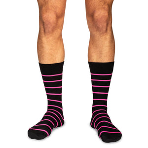 man wearing pink striped black dress socks