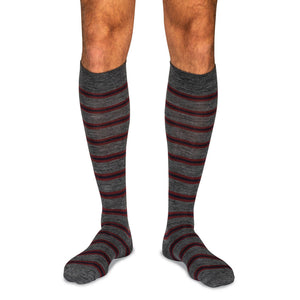 man wearing grey wool over the calf dress socks with burgundy and navy stripes