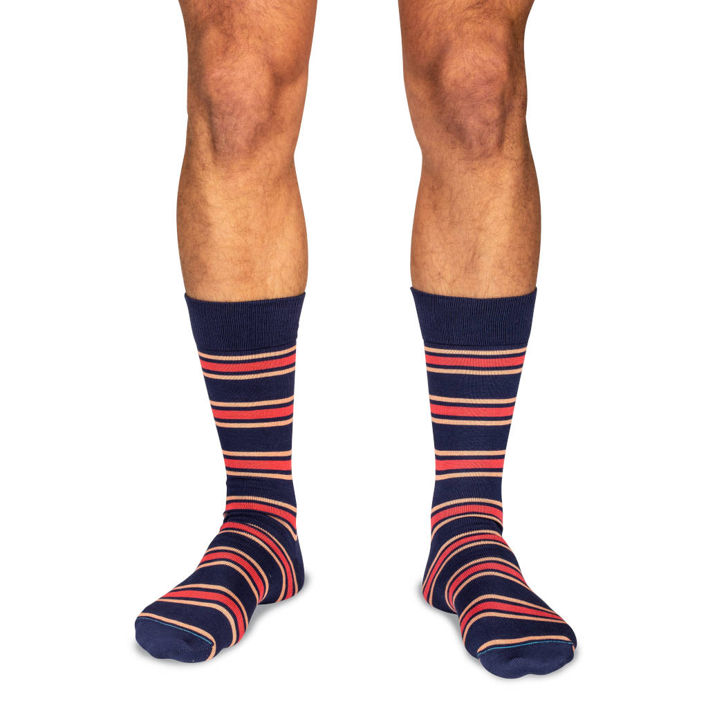 model wearing navy dress socks with colorful stripes