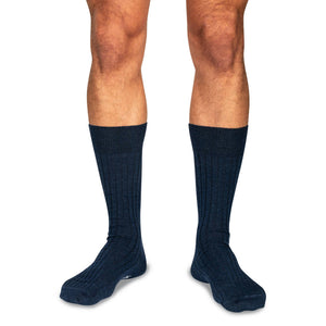 model standing wearing navy merino wool mid-calf length dress socks
