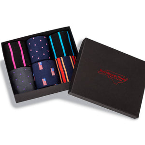 opened gift box filled with colorful patterned dress socks