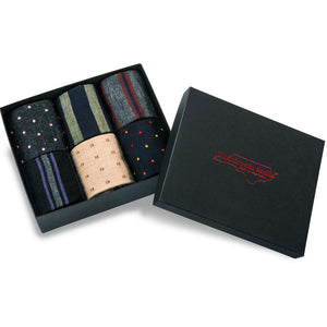 opened gift box displaying six pairs of patterned merino wool dress socks