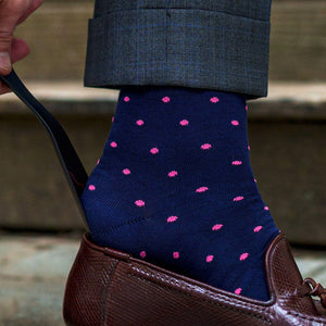 navy dress socks with bright pink dots sliding into loafers