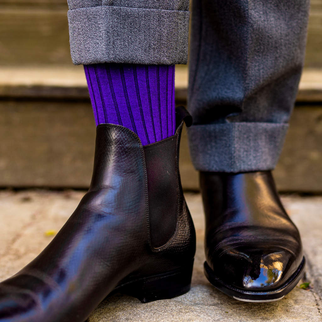 lifted pant leg showing purple wool dress socks